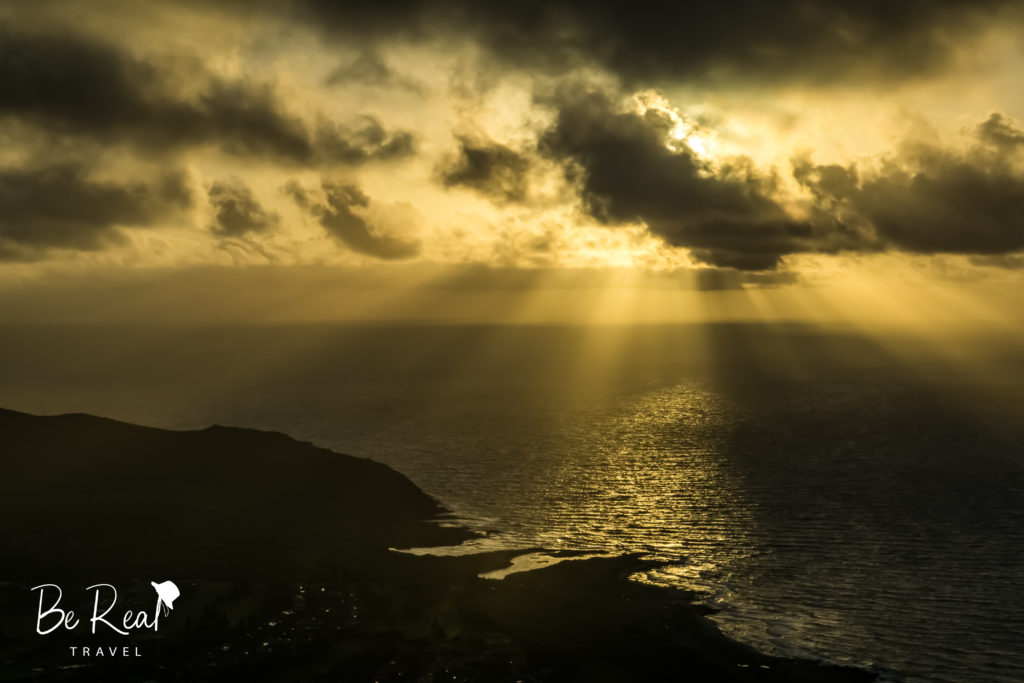 Sun rays burst from the clouds in this ocean view from Koko Crater Trail, Oahu, Hawaii