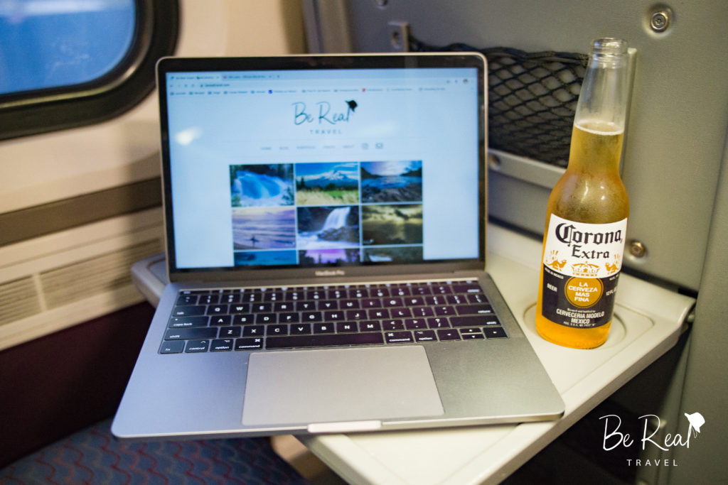 Scene showing why I enjoy my super commute - Laptop and Corona beer on Amtrak train, California