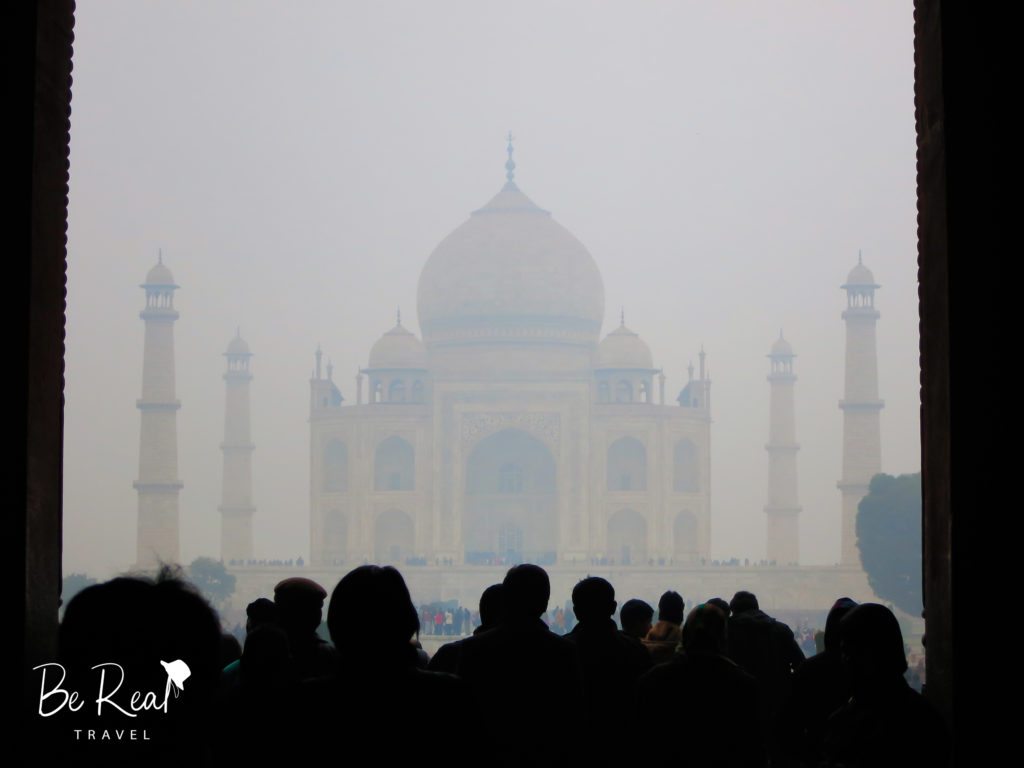 Tourists admire the Taj Mahal through the fog in Agra, part of India's golden triangle
