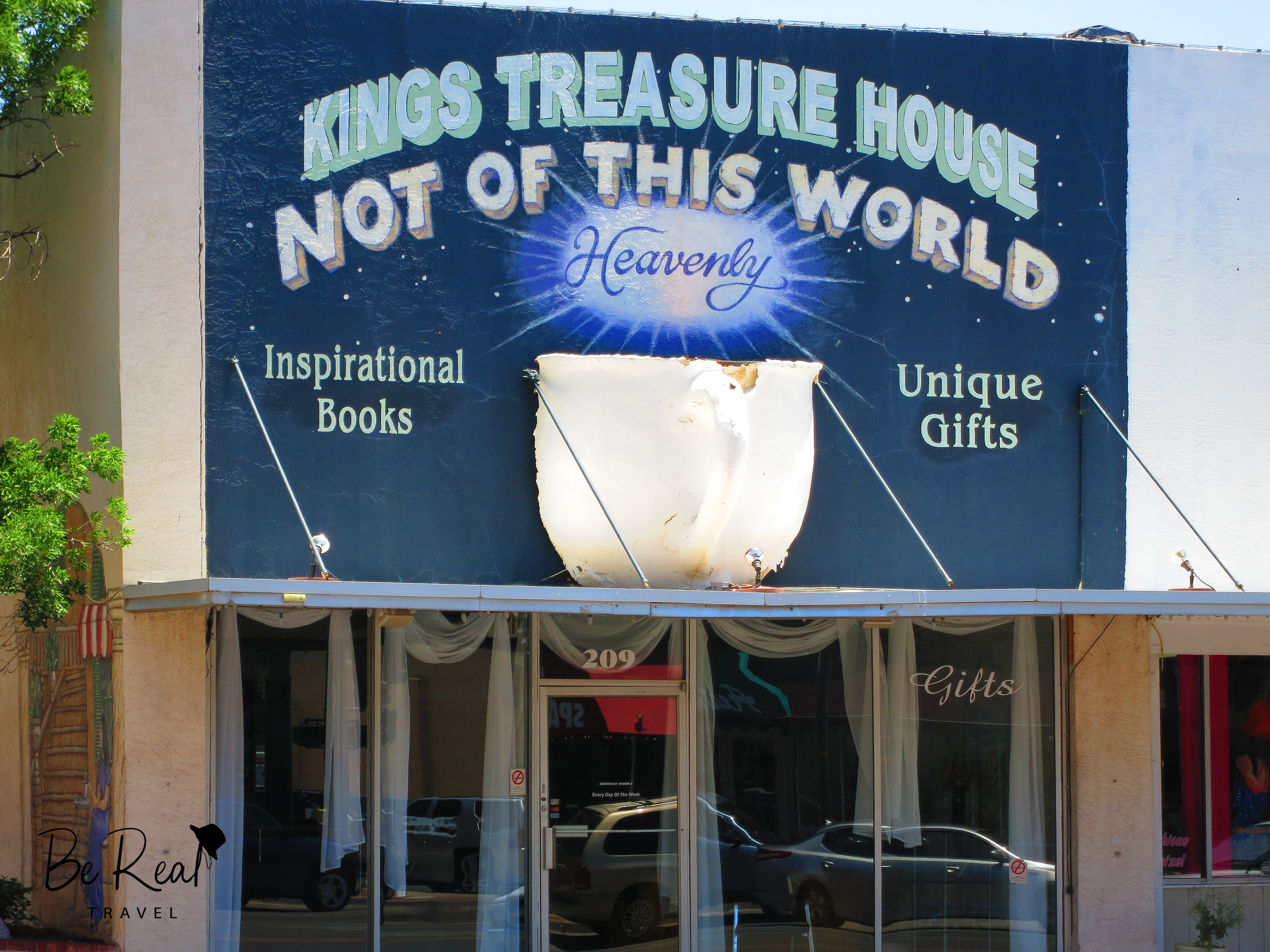 A giant cup is showcased on a store sign for Kings Treasure House gift and book shop in Roswell, New Mexico