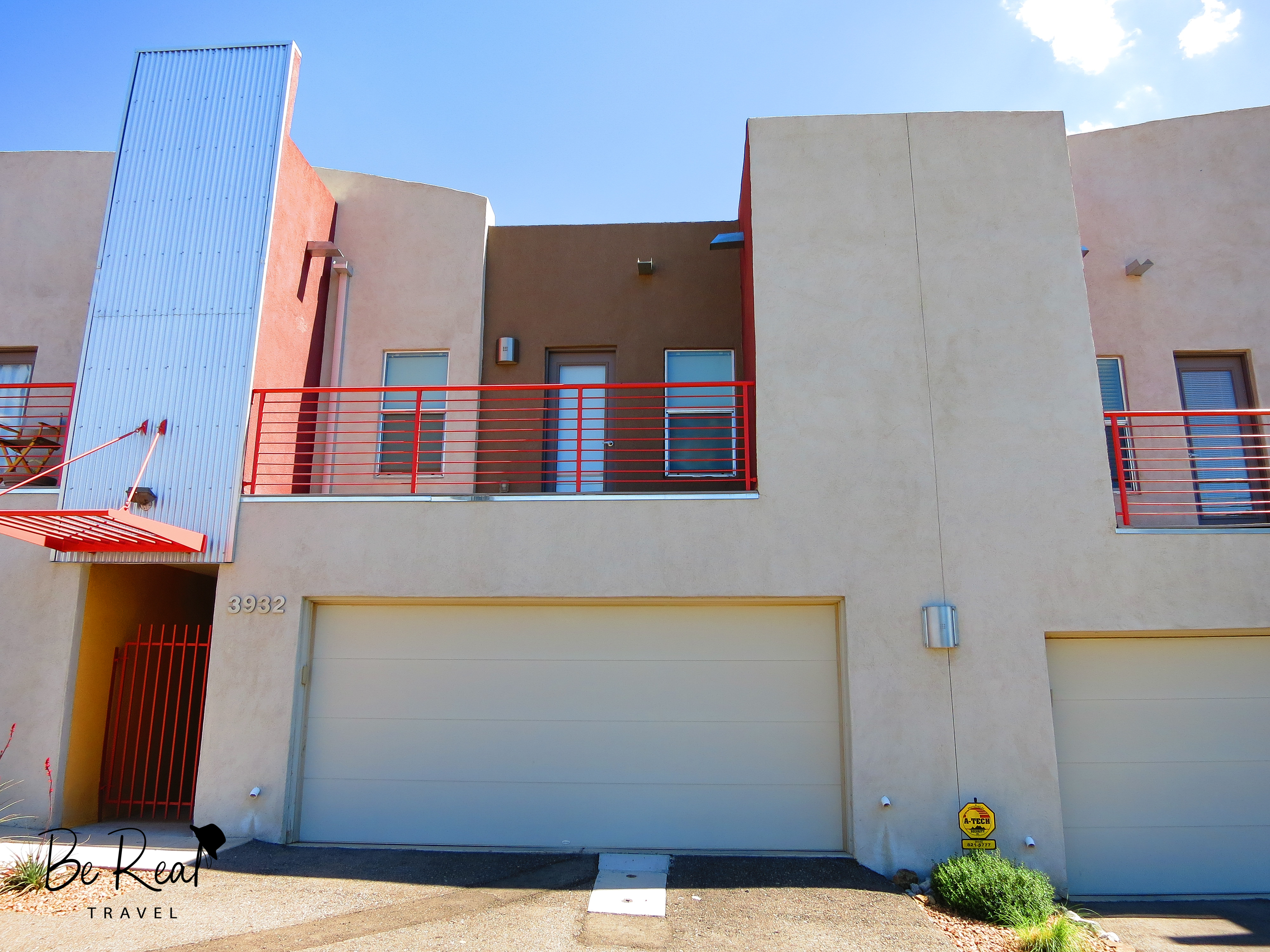 A two story, minimalistic apartment is accented with splashes of red; this apartment was Walter White's bachelor pad in New Mexico Breaking Bad
